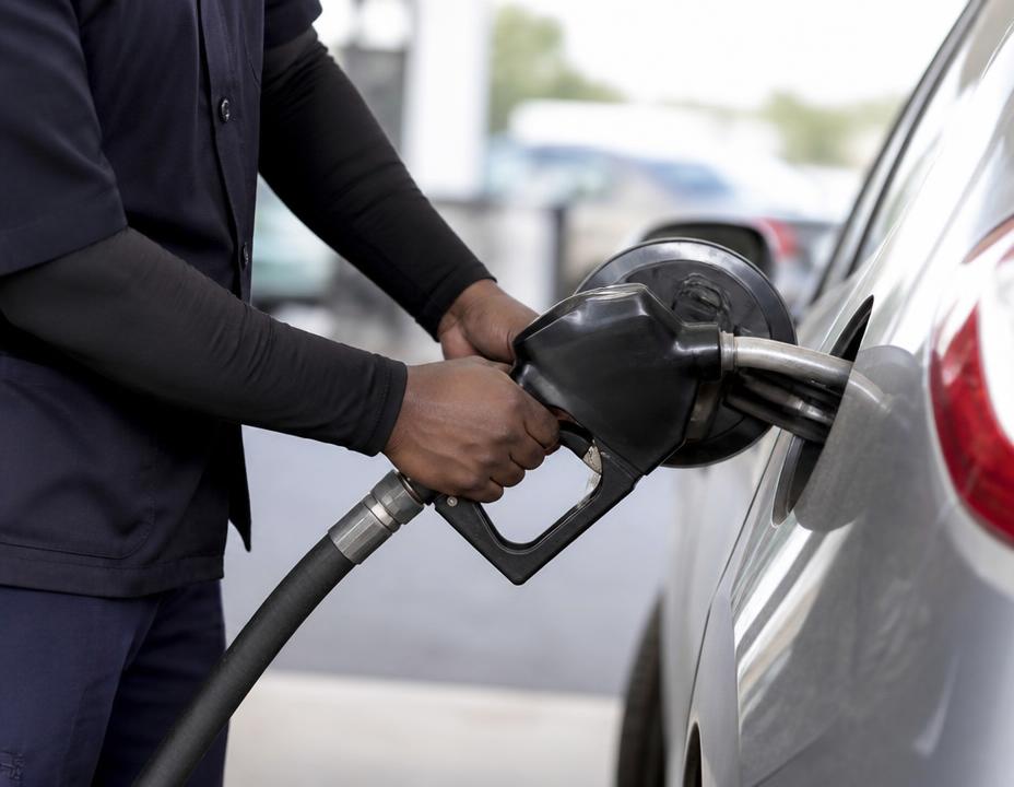 A fuel nozzle being placed into a vehicle tank